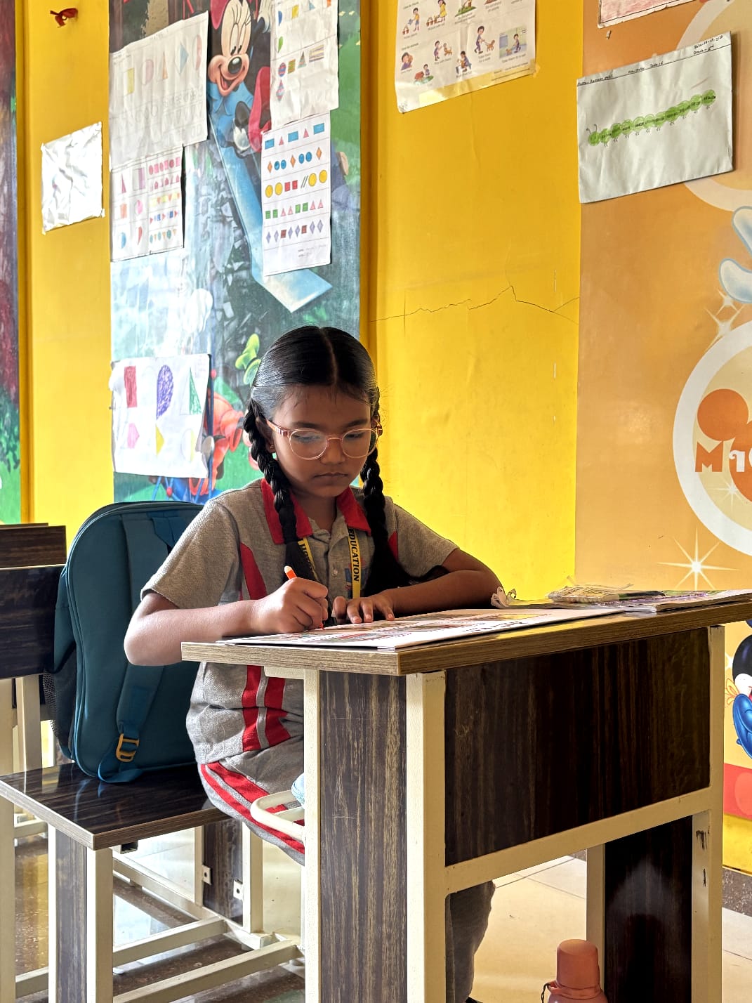 Students actively learning in a bright, modern classroom at Chanakya School
